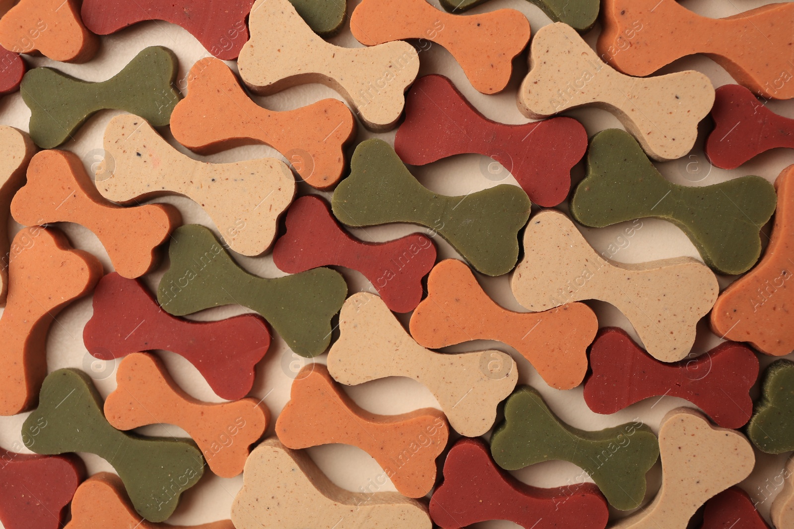 Photo of Flat lay composition with many bone shaped vitamins for pets on beige background