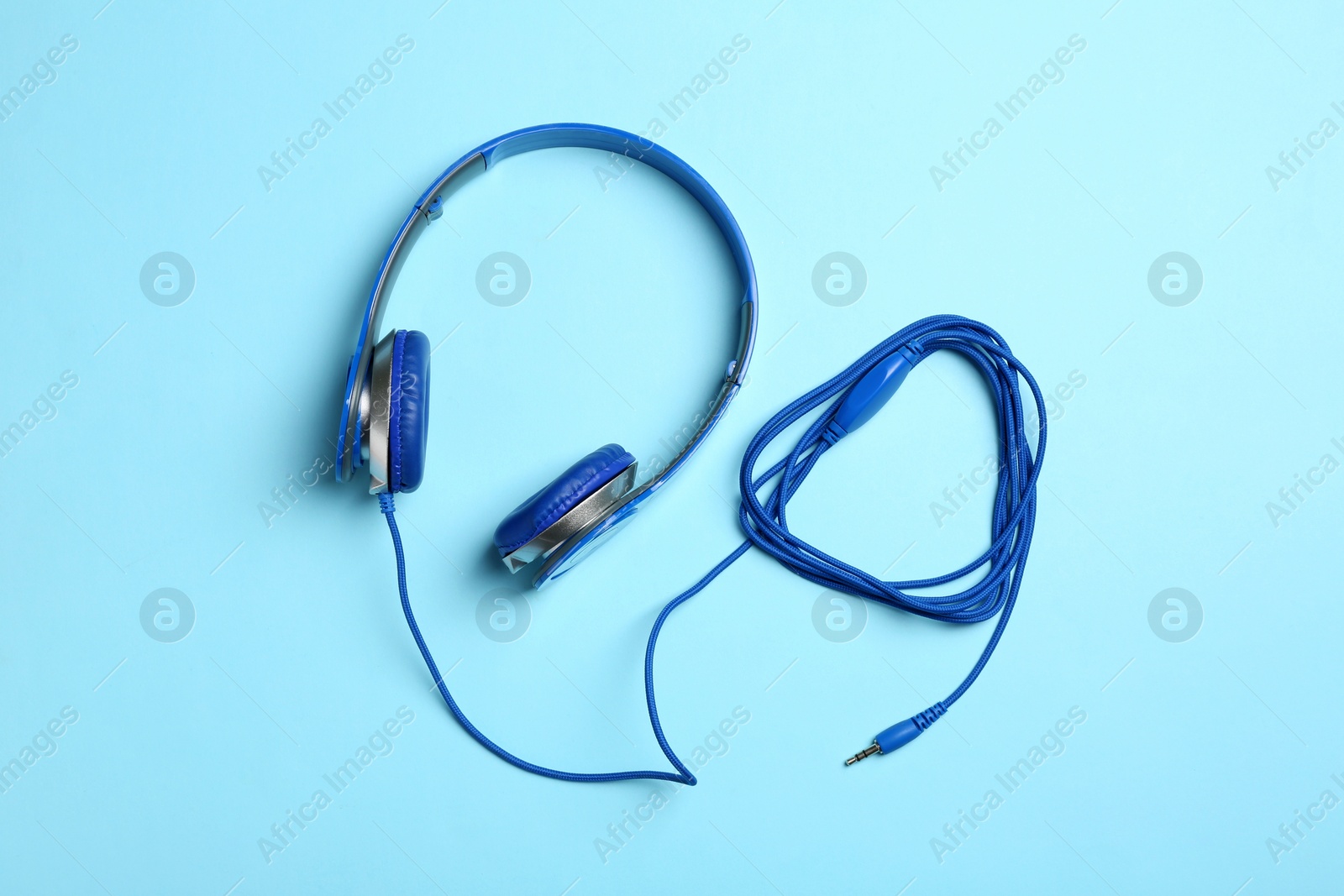 Photo of Stylish headphones on color background, top view