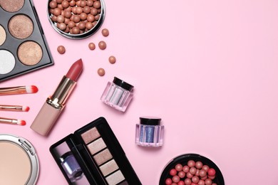 Photo of Flat lay composition with decorative cosmetics on  pink background, space for text