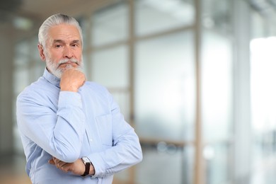 Image of Portrait of handsome senior man in office, space for text