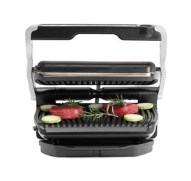 Electric grill with raw meat, zucchini and rosemary isolated on white, top view