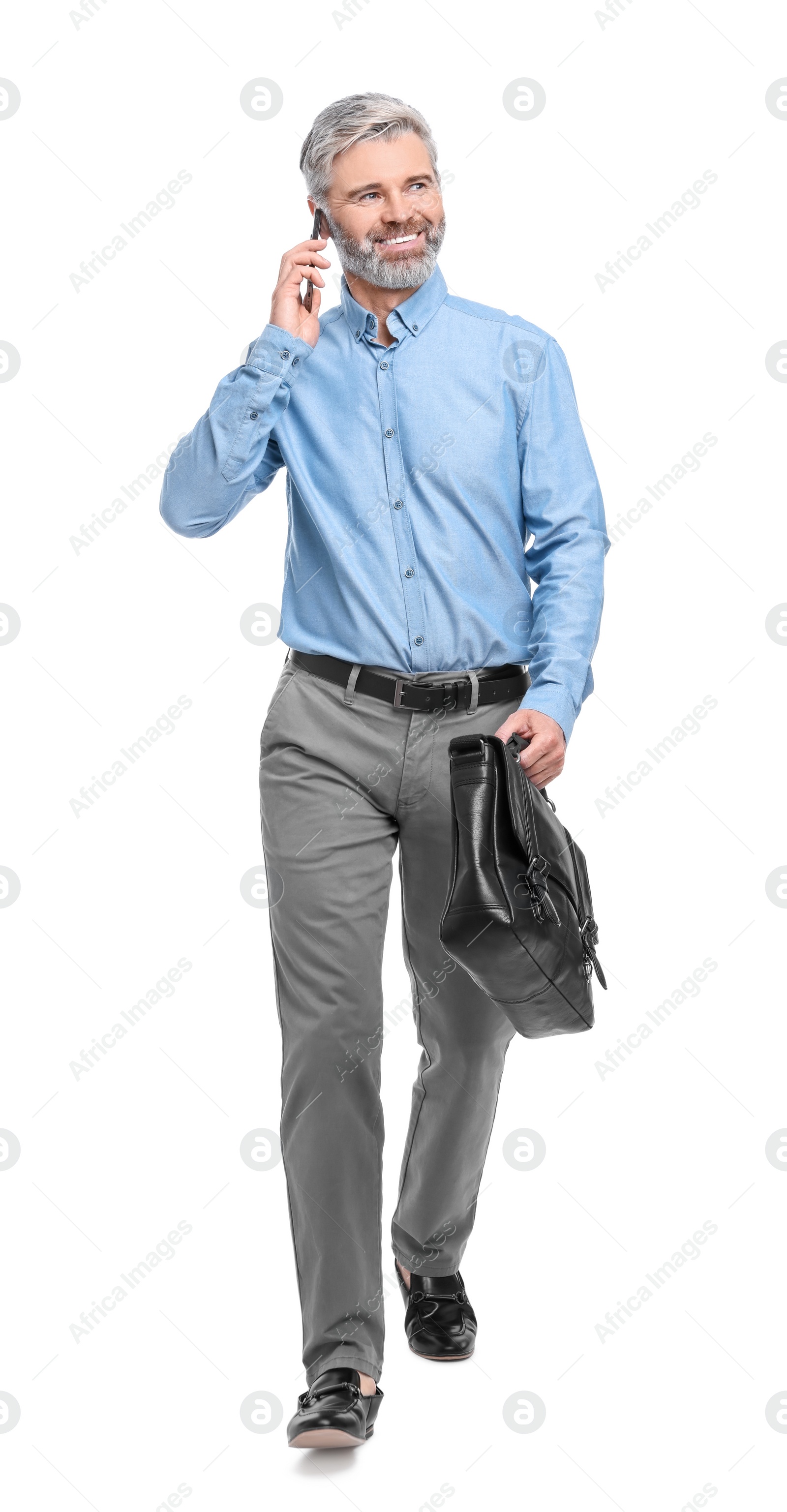 Photo of Mature businessman talking on smartphone against white background