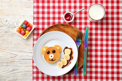 Photo of Flat lay composition with pancakes in form of bear on table. Creative breakfast ideas for children