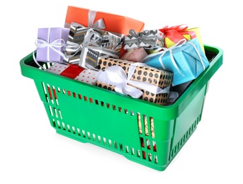 Photo of Green shopping basket with different gifts on white background