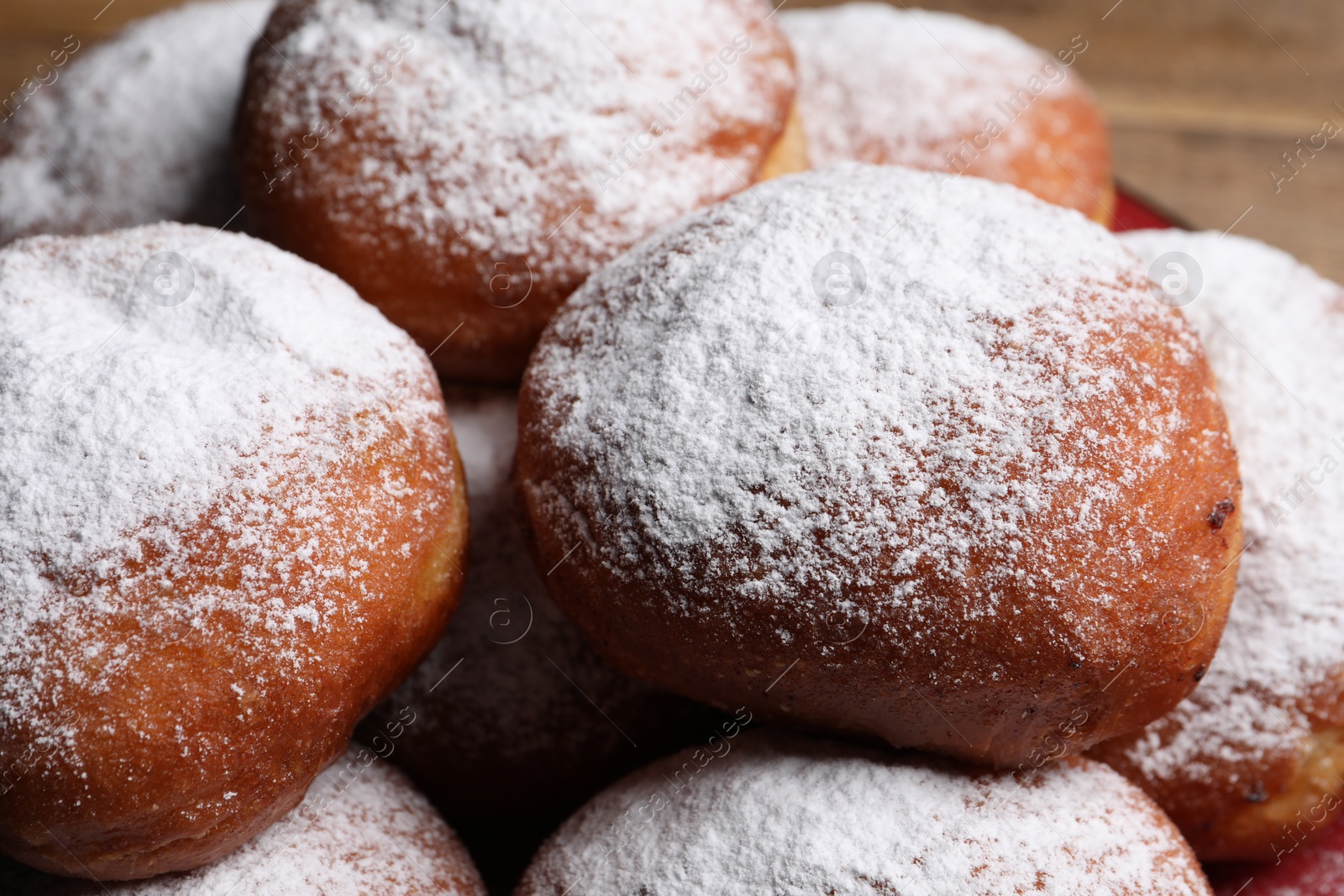 Photo of Delicious sweet buns with powdered sugar, closeup