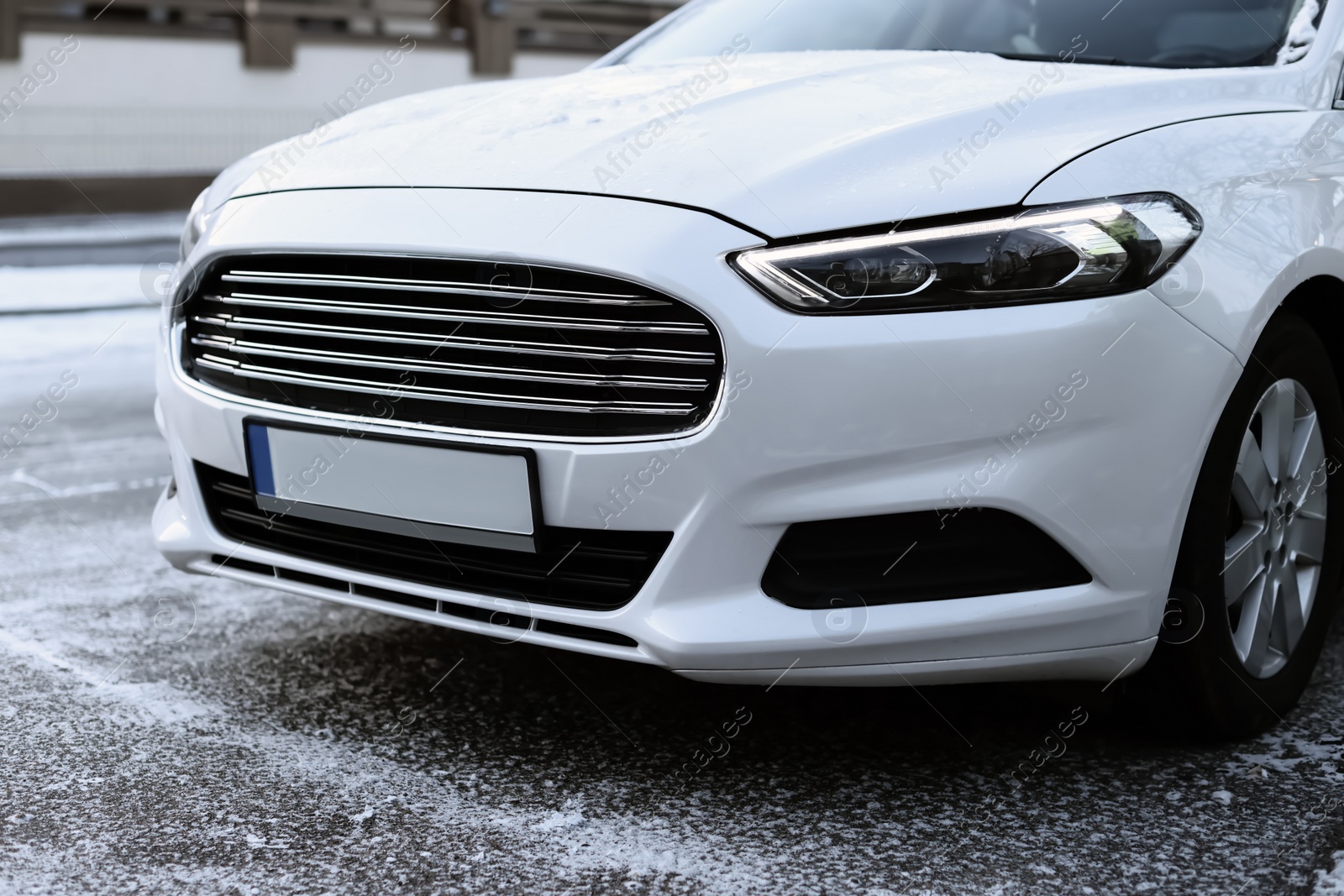 Photo of Modern white car outdoors on snowy day, closeup