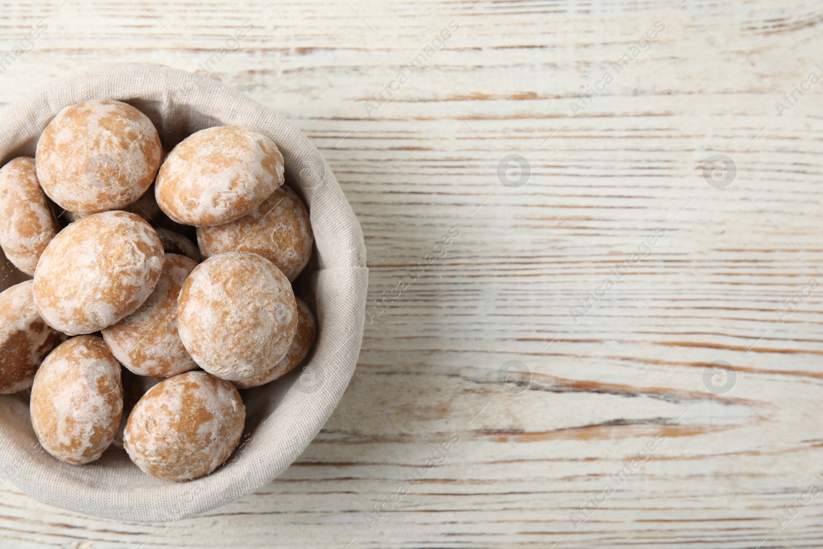 Photo of Tasty homemade gingerbread cookies on white wooden table, top view. Space for text