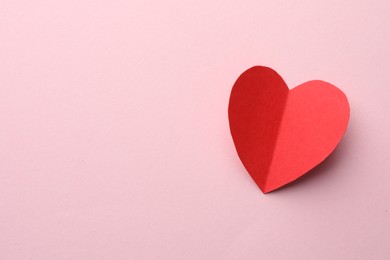 One paper heart on pink background, top view. Space for text