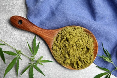 Photo of Hemp protein powder and fresh leaves on light grey table, flat lay