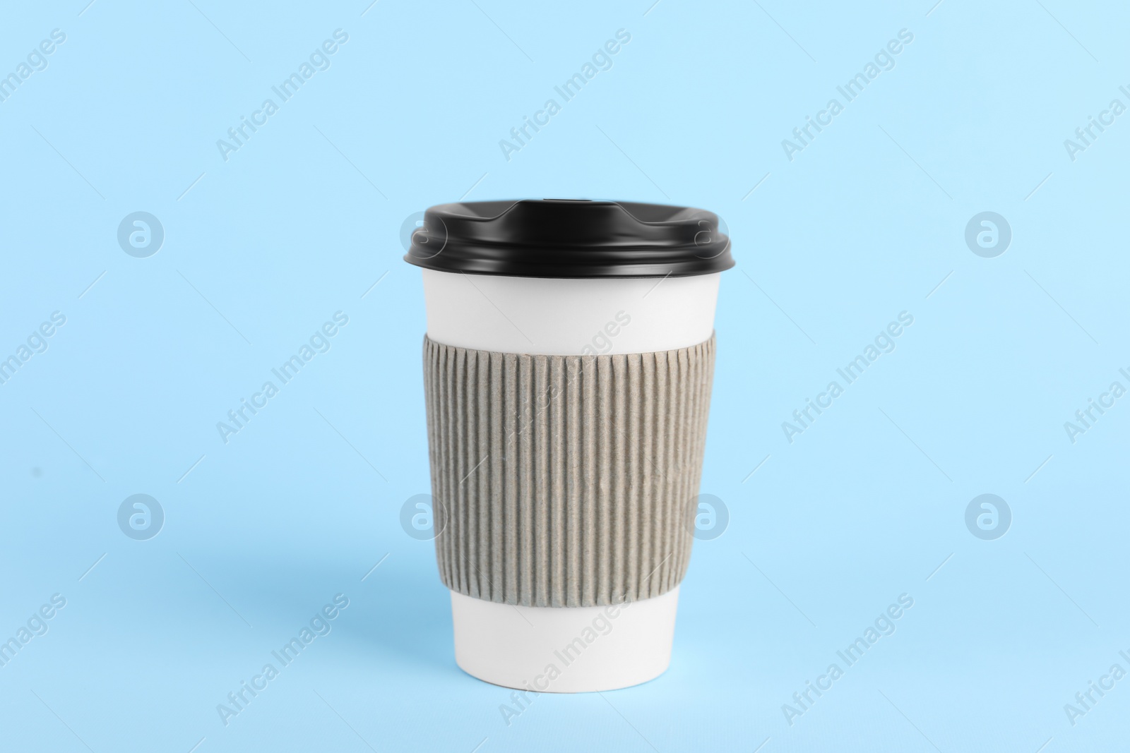 Photo of Paper cup with plastic lid on light blue background. Coffee to go