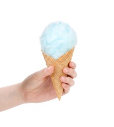 Photo of Woman holding waffle cone with cotton candy on white background, closeup