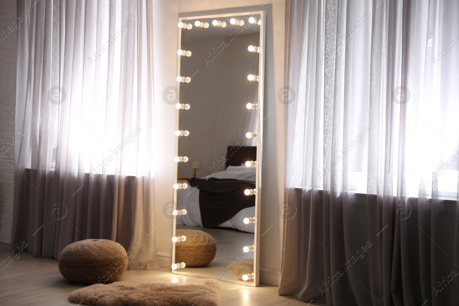 Photo of Large mirror with light bulbs in stylish room interior