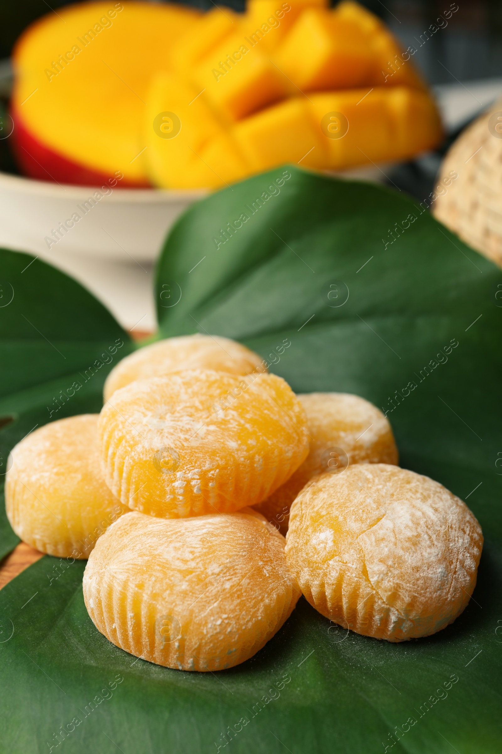 Photo of Delicious mochi on green leaf, closeup. Traditional Japanese dessert