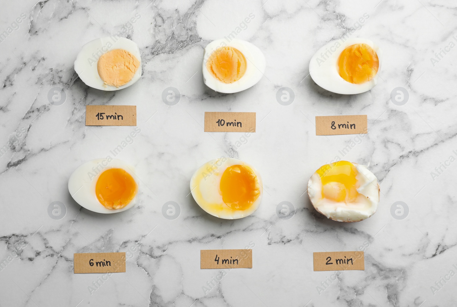 Photo of Various types of boiled eggs on marble background, flat lay. Cooking time