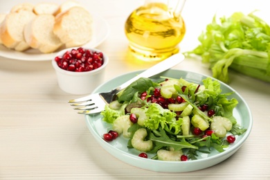 Photo of Delicious fresh celery salad on white wooden table