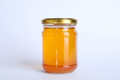 Photo of Glass jar of sunflower honey isolated on white