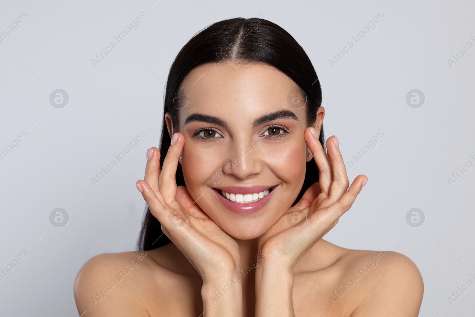 Photo of Portrait of attractive young woman on light grey background. Spa treatment