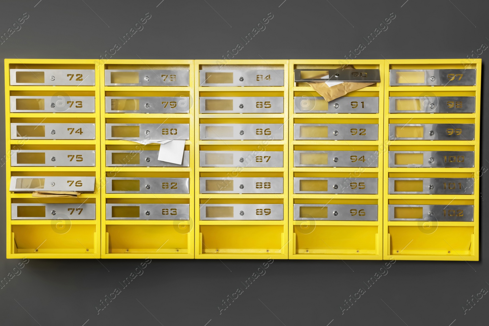 Photo of Metal mailboxes with keyholes, numbers and correspondence in post office