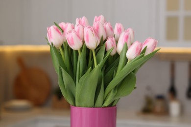 Beautiful bouquet of fresh pink tulips in kitchen