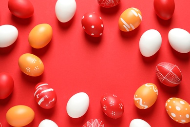 Photo of Flat lay composition with painted Easter eggs on color background, space for text