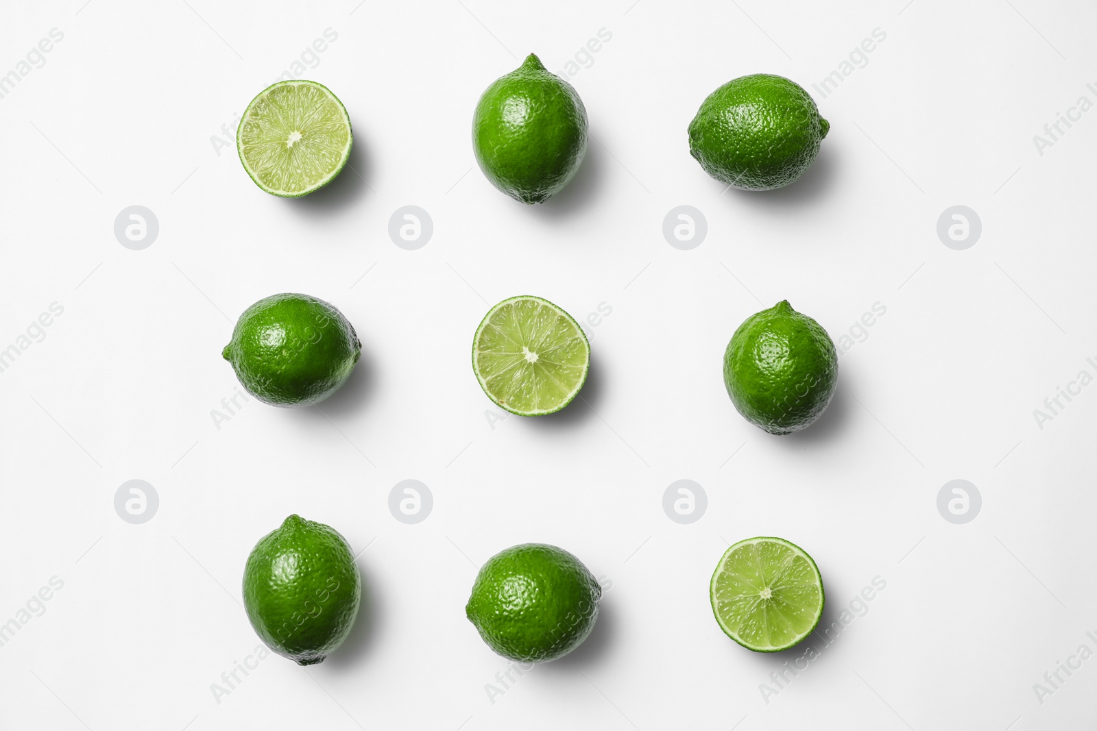 Photo of Flat lay composition with fresh juicy limes on white background