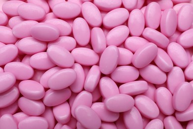 Photo of Many pink dragee candies as background, closeup