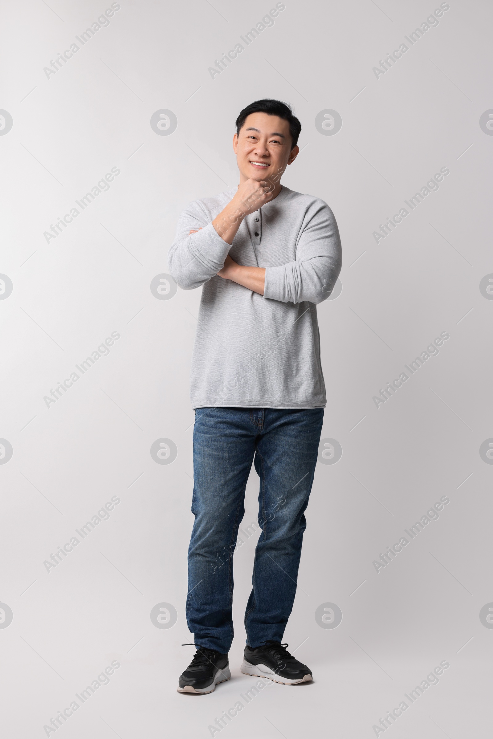 Photo of Full length portrait of happy man on light background