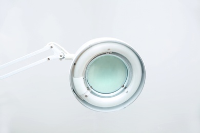 Medical lamp with magnifying glass in modern clinic