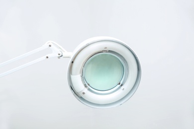 Photo of Medical lamp with magnifying glass in modern clinic