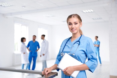 Female doctor in uniform with tablet at workplace