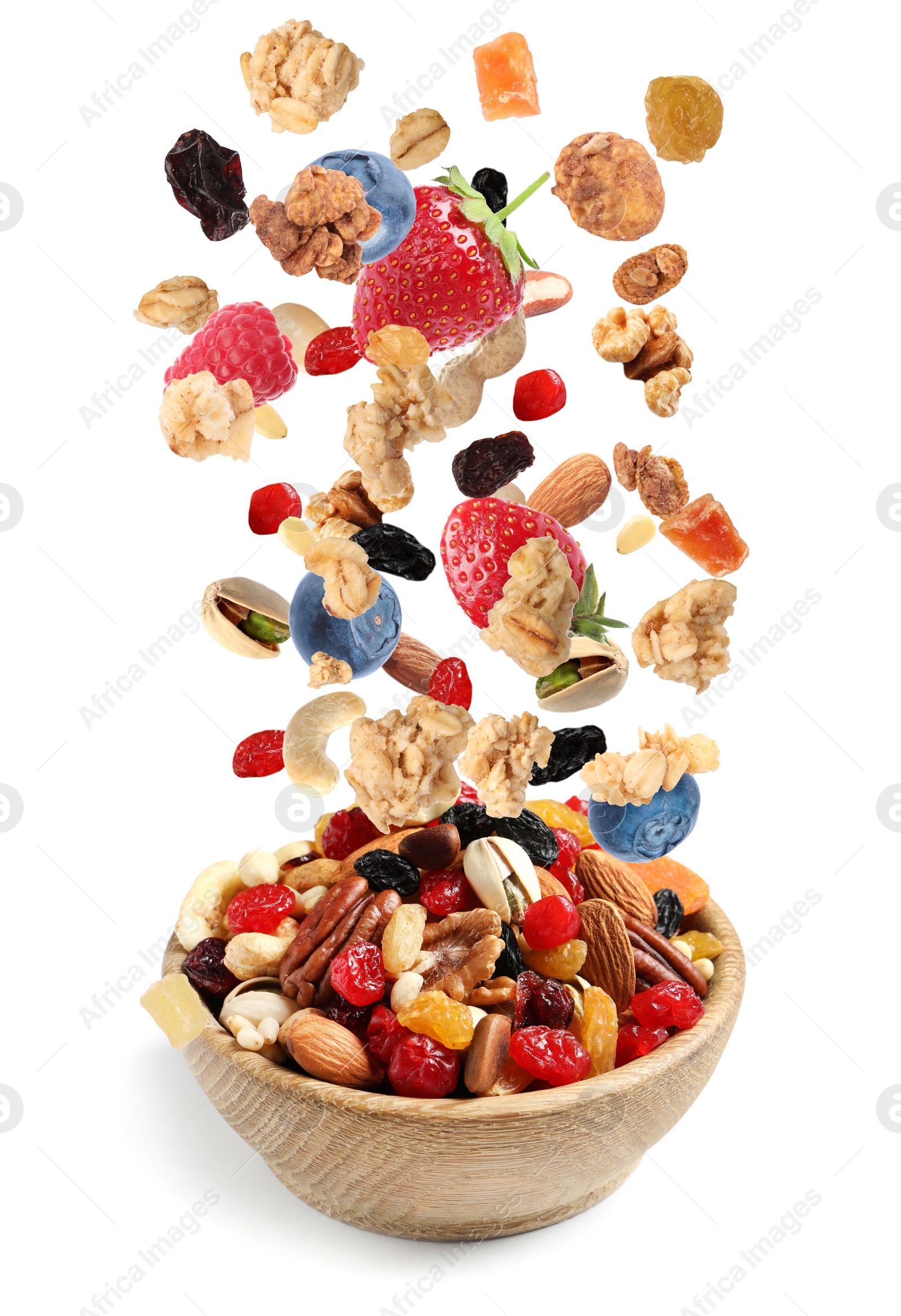 Image of Delicious granola, nuts and berries falling into bowl on white background. Healthy snack 