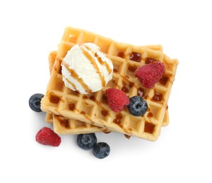 Photo of Tasty Belgian waffles with ice cream, berries and caramel syrup on white background, top view