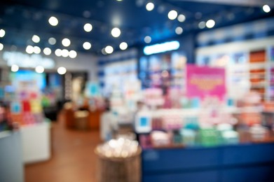 Photo of Blurred view of store with different goods, bokeh effect