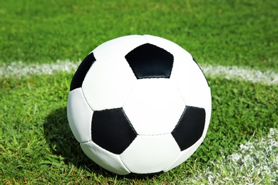 Photo of Soccer ball on fresh green football field grass