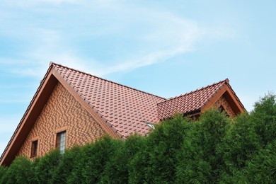 Photo of Beautiful house with red roof against blue sky