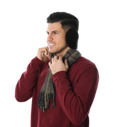 Photo of Man wearing stylish earmuffs and scarf on white background