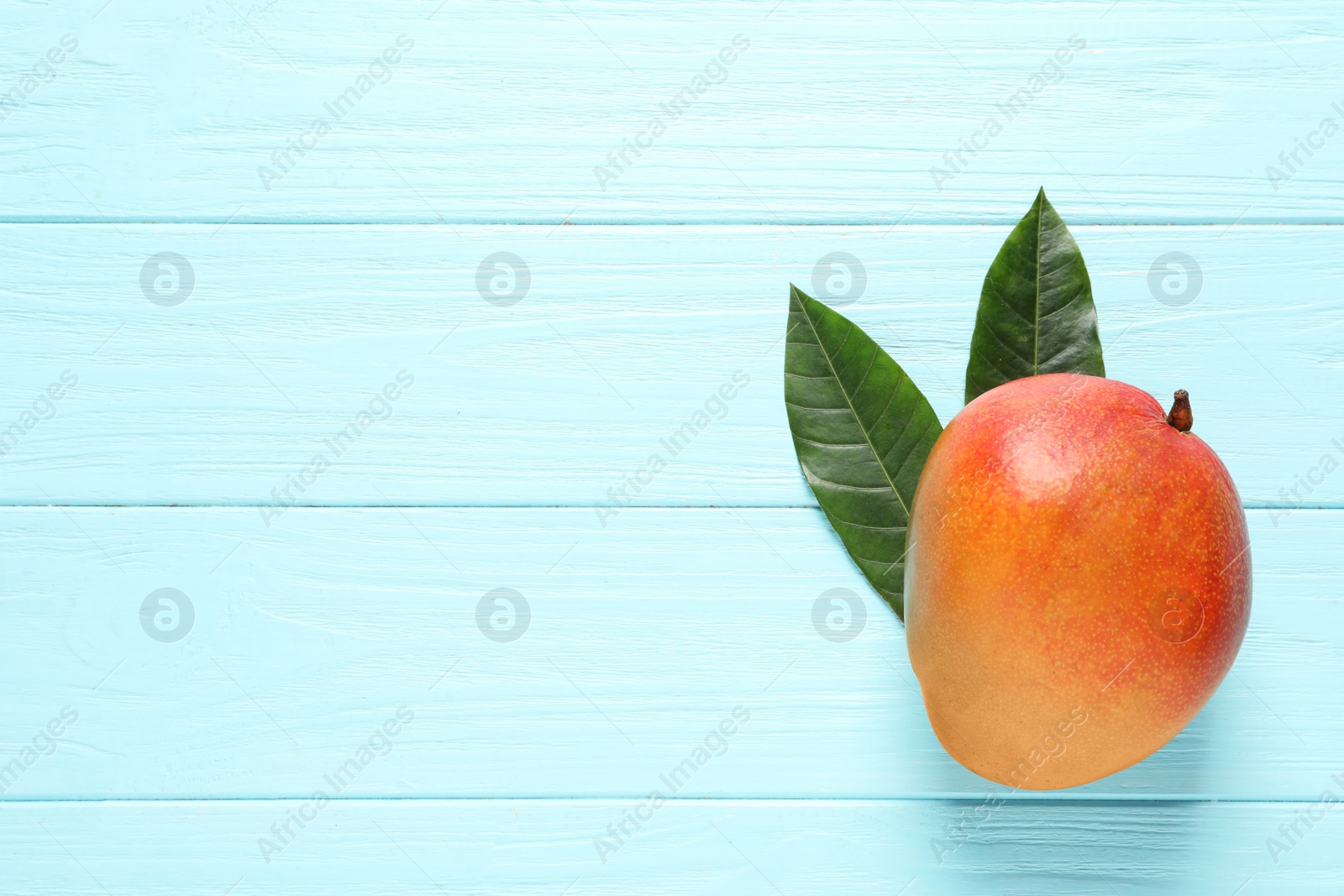 Photo of Flat lay composition with mango on color wooden background. Space for text