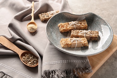 Plate with different homemade grain cereal bars on table. Healthy snack