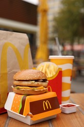 Photo of Lviv, Ukraine - October 9, 2023: McDonald's menu on wooden table outdoors