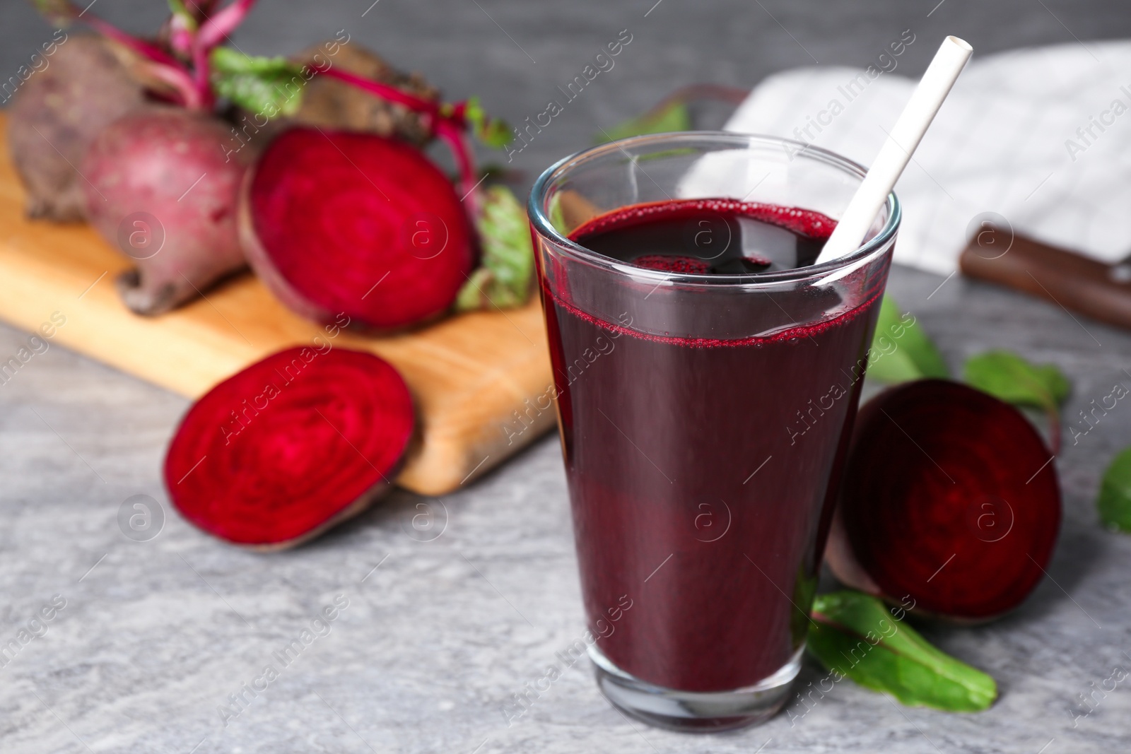 Photo of Freshly made beet juice on grey table