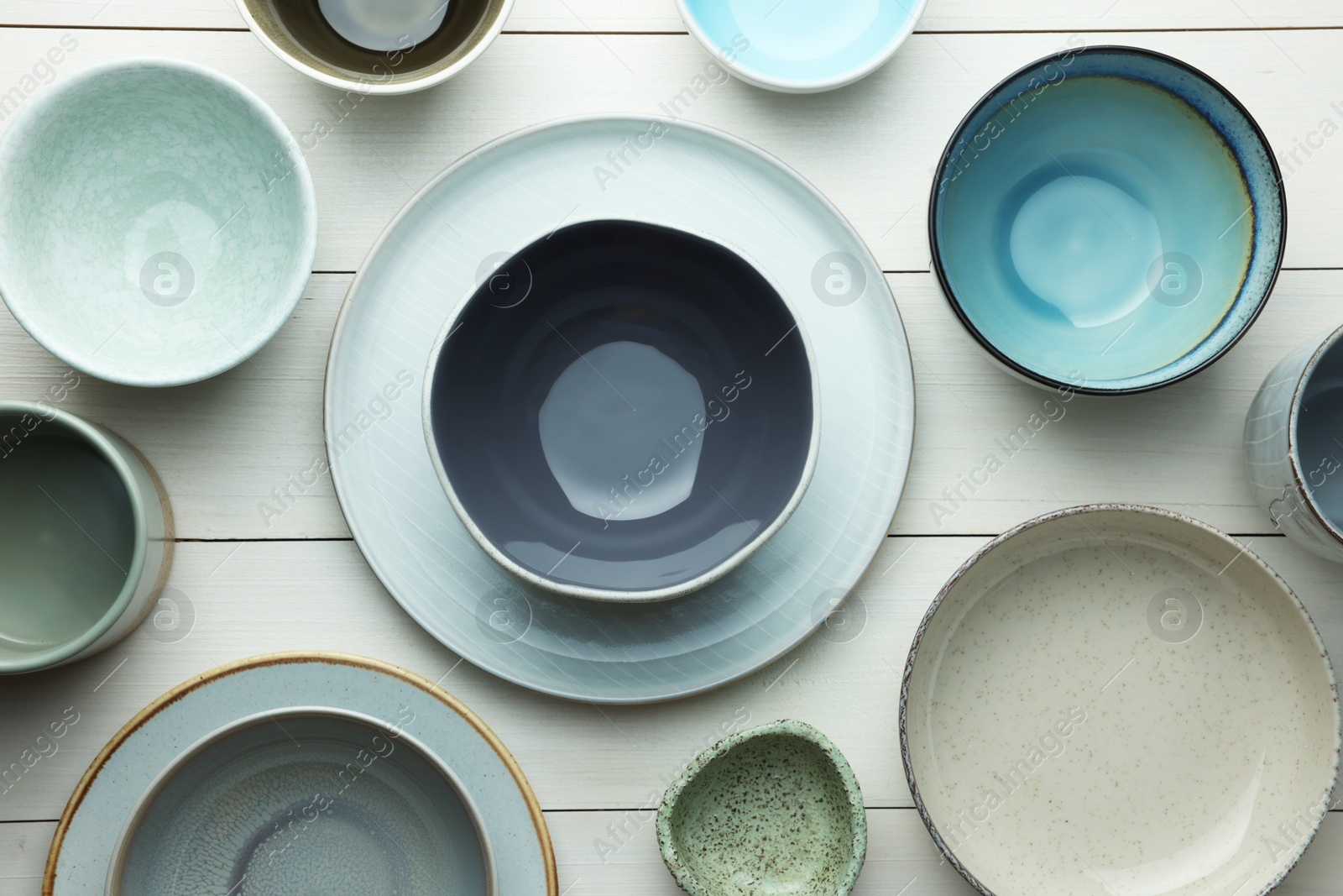 Photo of Stylish empty dishware on white wooden table, flat lay