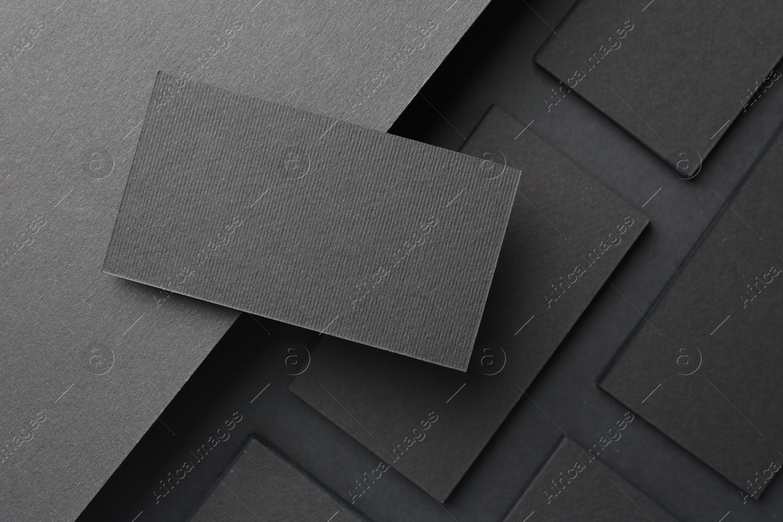 Photo of Blank business cards on black background, flat lay. Mockup for design