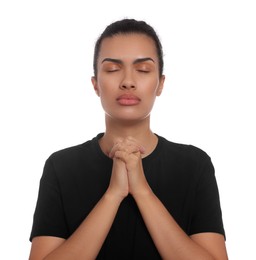 Photo of African American woman with clasped hands praying to God on white background