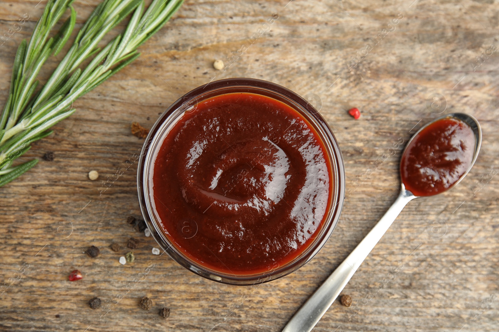 Photo of Flat lay composition with barbecue sauce on wooden background