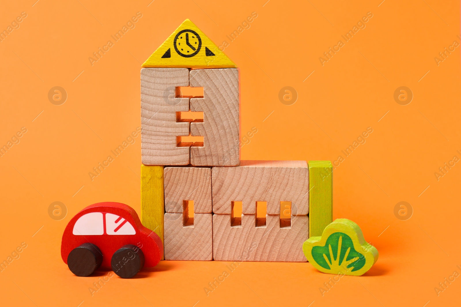 Photo of Set of wooden toys on orange background. Children's development