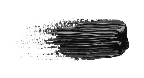 Photo of Brushstroke of black oil paint on white background, top view