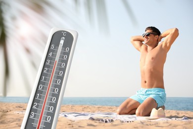 Image of Weather thermometer and happy man resting on beach. Heat stroke warning