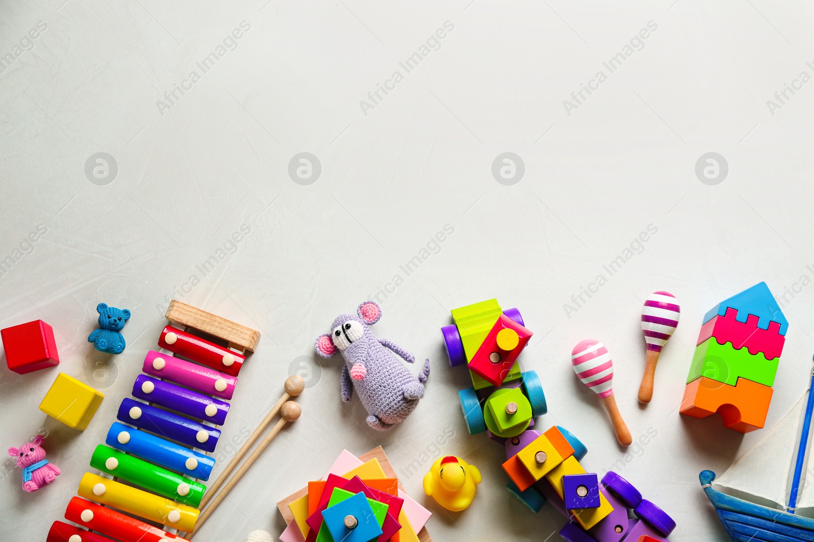 Photo of Different toys on light background, flat lay. Space for text