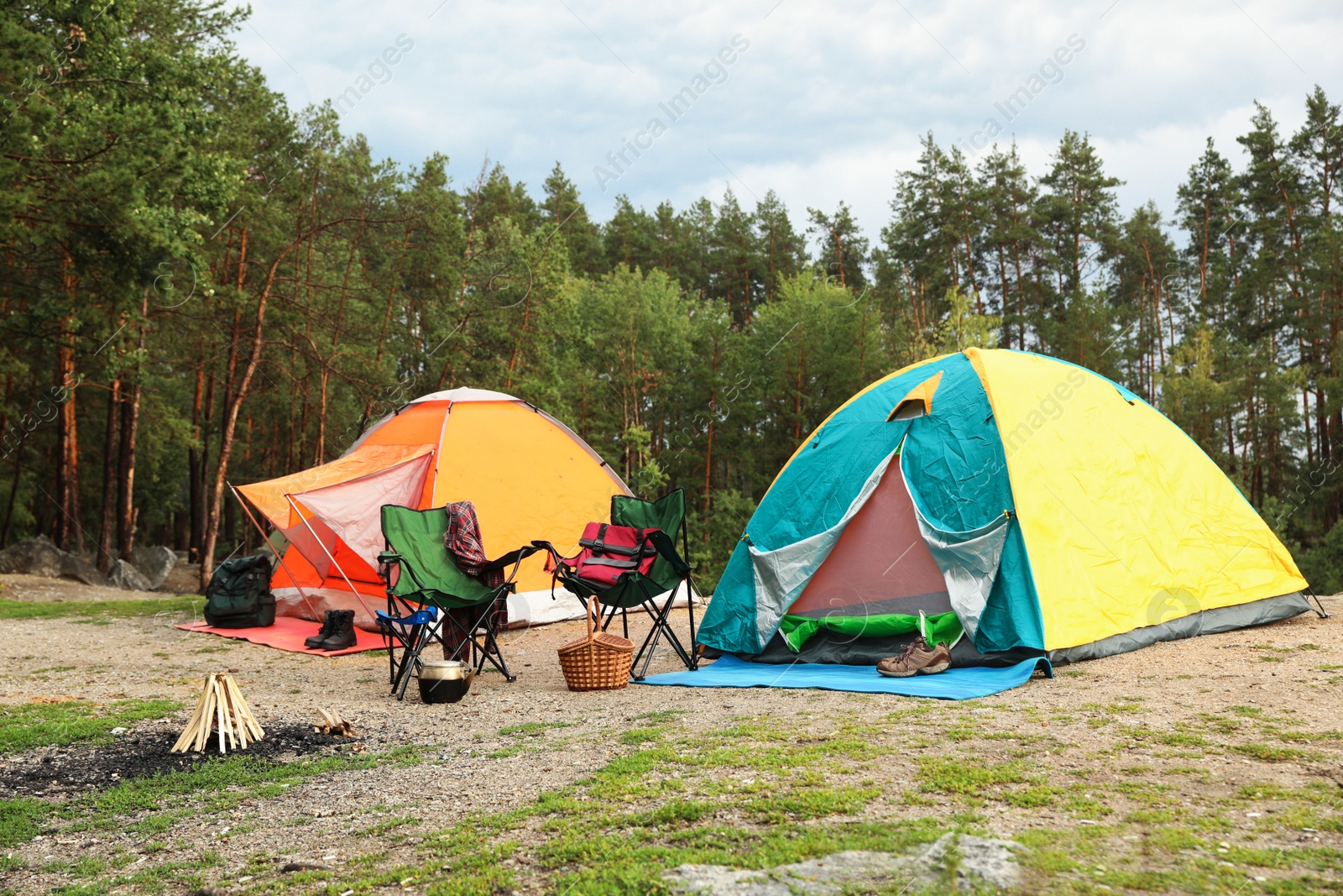 Photo of Camping tents and accessories in wilderness on summer day