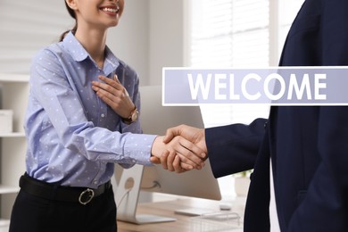 Welcome to team. Employee shaking hands with intern in office, closeup